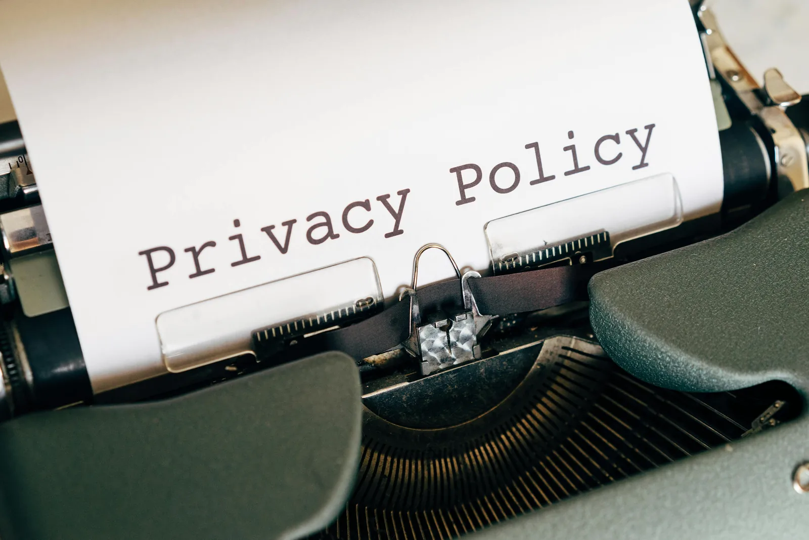 A typewriter with a sheet of paper reading Privacy Policy